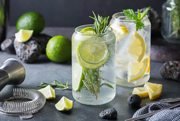 Hard seltzer cocktails with lime and lemon on a table. Summer refreshing beverage, drink