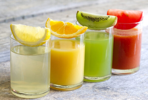 Fresh juice in glass with slices of fruits and vegetables